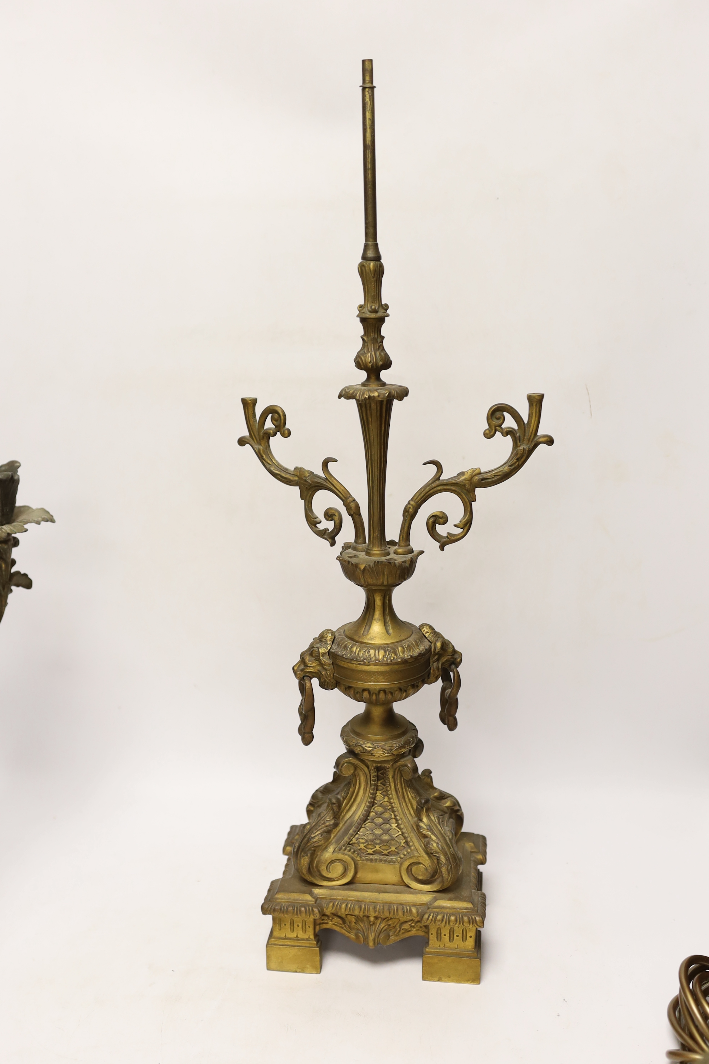 A pair of brass lustre drop candlesticks, lamp base and three branch candelabra, 59cm high